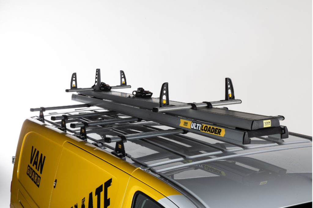 A yellow and black van with ladders on the back
Description automatically generated