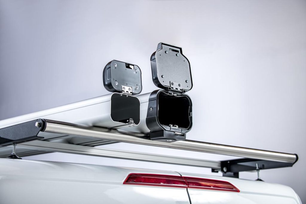 Unlined standard pipe carrier and lined maxi pipe carrier open placed on van roof bars on top of a van