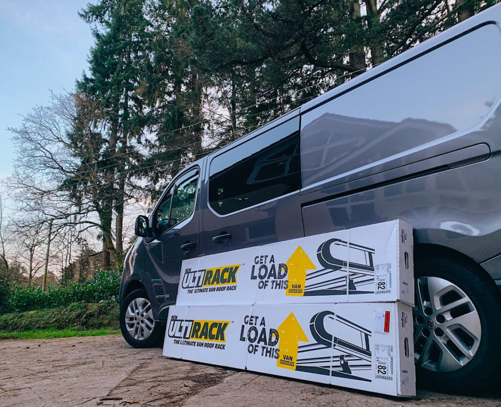 Campervan with the ULTI Rack packaging next to it